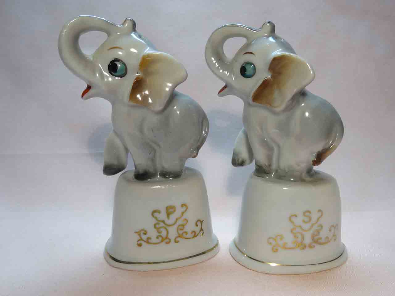 Elephants sitting on dinner bells salt and pepper shakers