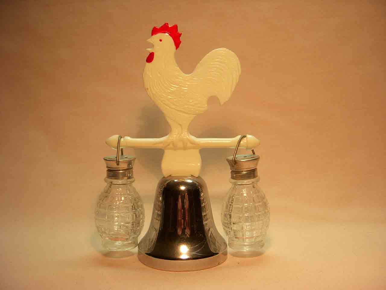 Plastic rooster on dinner bell with hanging salt and pepper shaker