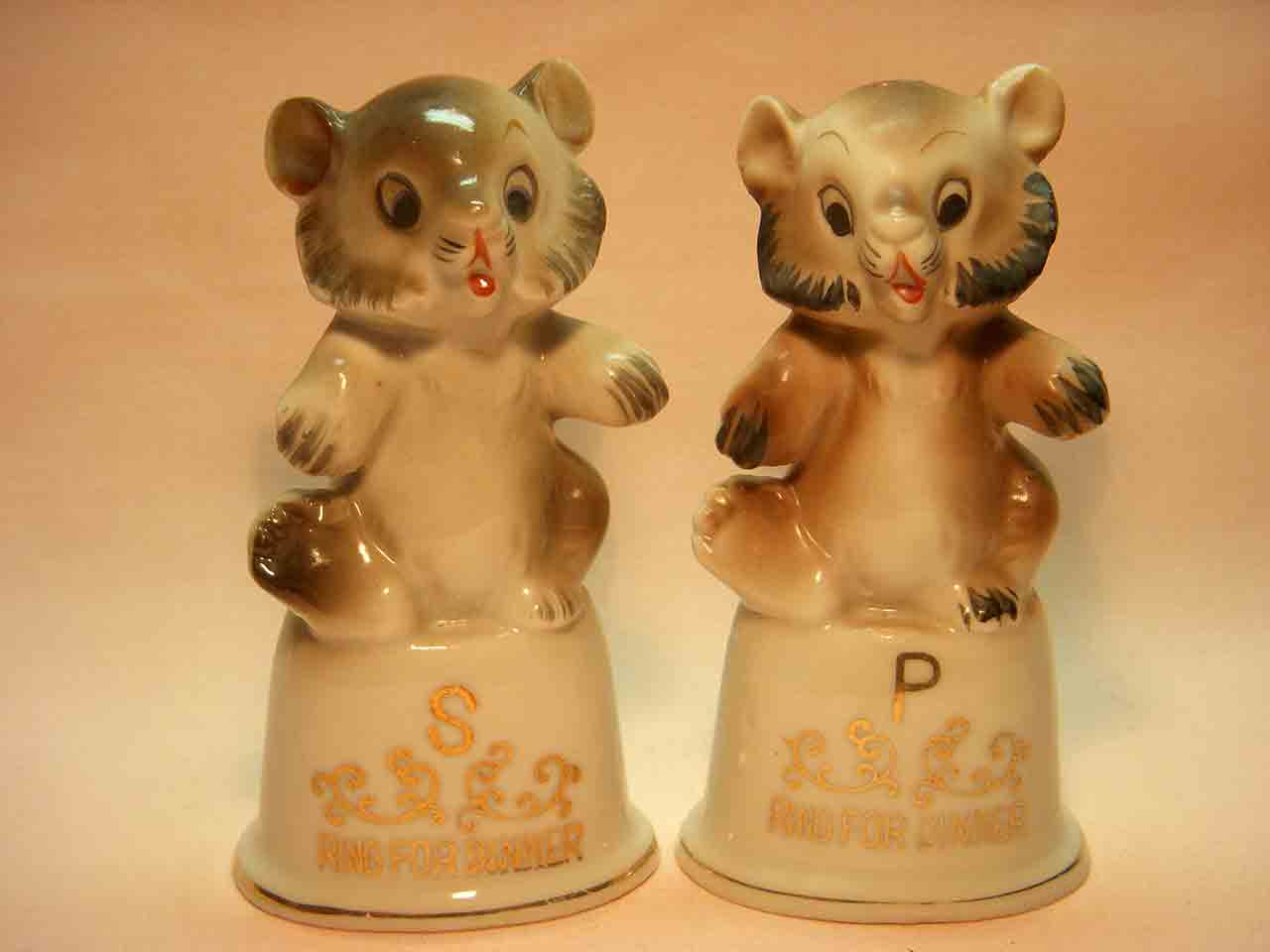 Bears sitting on top of dinner bells salt and pepper shakers
