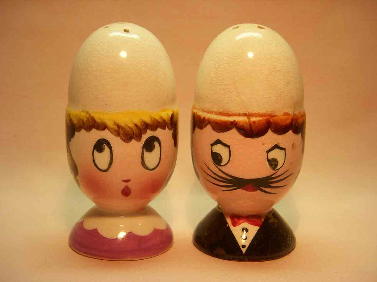 Eggs in egg cup heads salt and pepper shaker