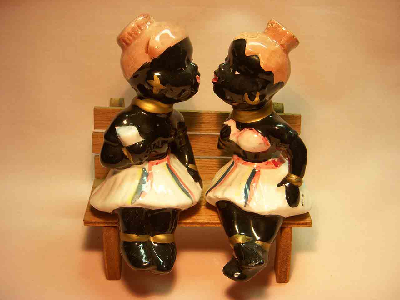 Black natives kissing sitting on wooden bench salt and pepper shaker